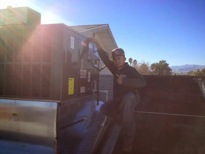 HVAC technician performing HVAC Inspection on a rooftop unit in Pottsville
