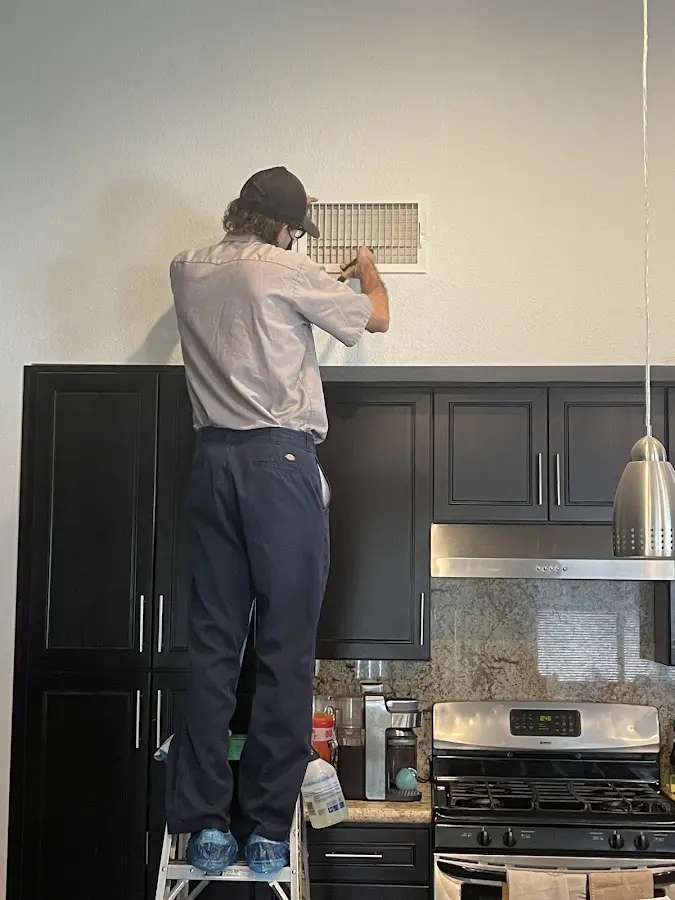 Technician inspecting an air vent during HVAC service in Pottsville
